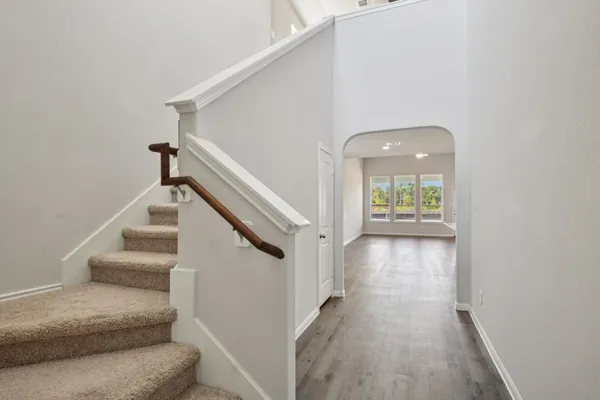 a view of entryway and hall with wooden floor