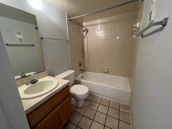 a bathroom with a double vanity sink mirror and toilet