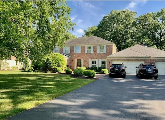 a view of a house with a yard and sitting area