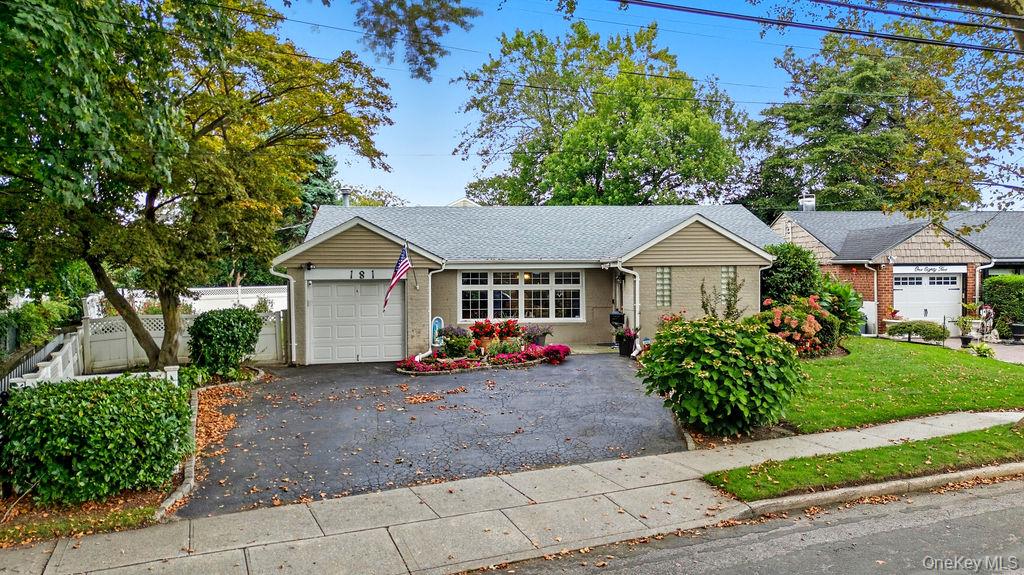 181 Tottenham Road Lynbrook, NY 11563 - Photo 1 of 1 Single story home featuring an attached garage, asphalt driveway, brick siding, and roof with shingles