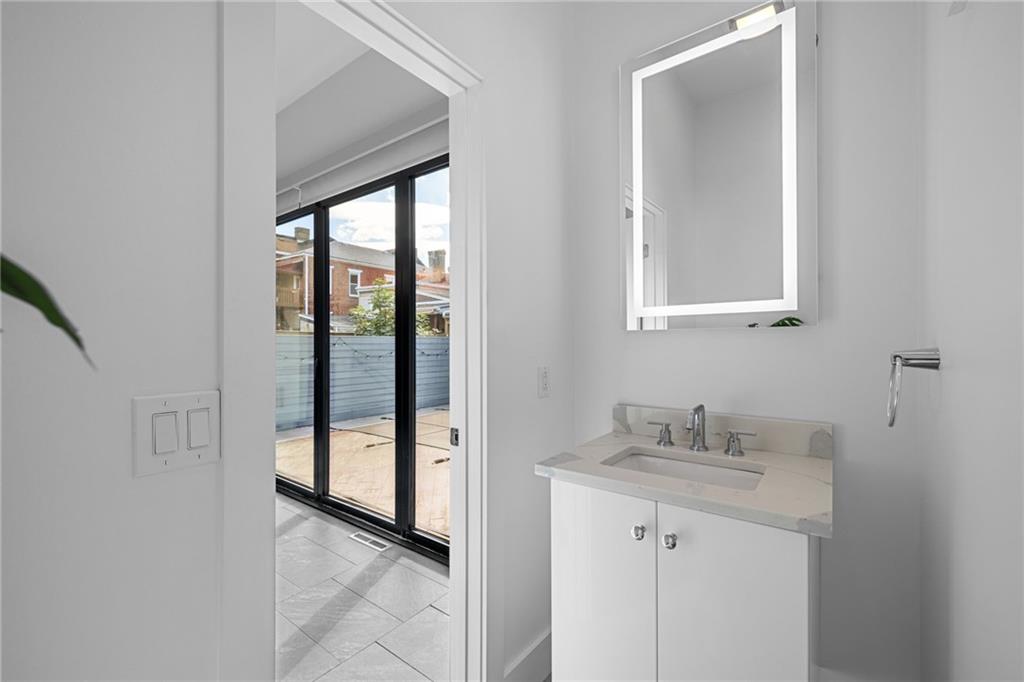 127 1/2 Banner Way Pittsburgh, PA 15201 - Photo 12 of 48 a bathroom with a sink and a mirror