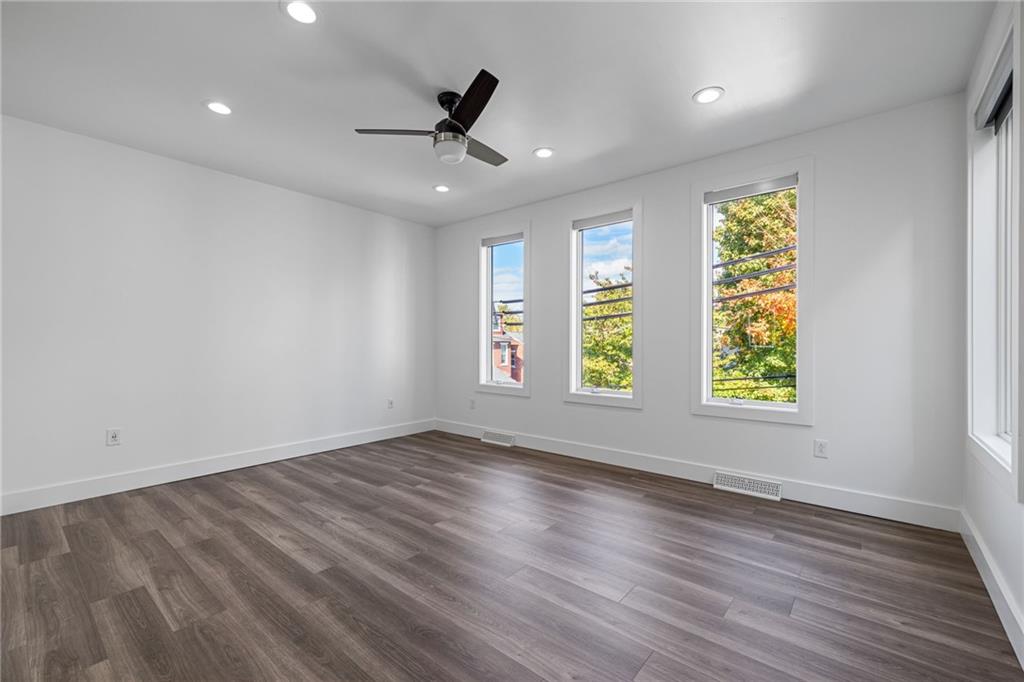127 1/2 Banner Way Pittsburgh, PA 15201 - Photo 15 of 48 a view of an empty room with wooden floor and a window