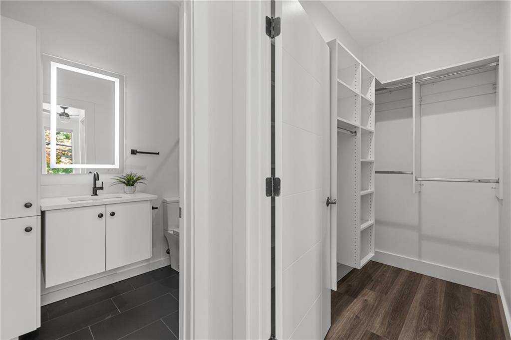 127 1/2 Banner Way Pittsburgh, PA 15201 - Photo 18 of 48 a bathroom with a double vanity sink a mirror and a shower