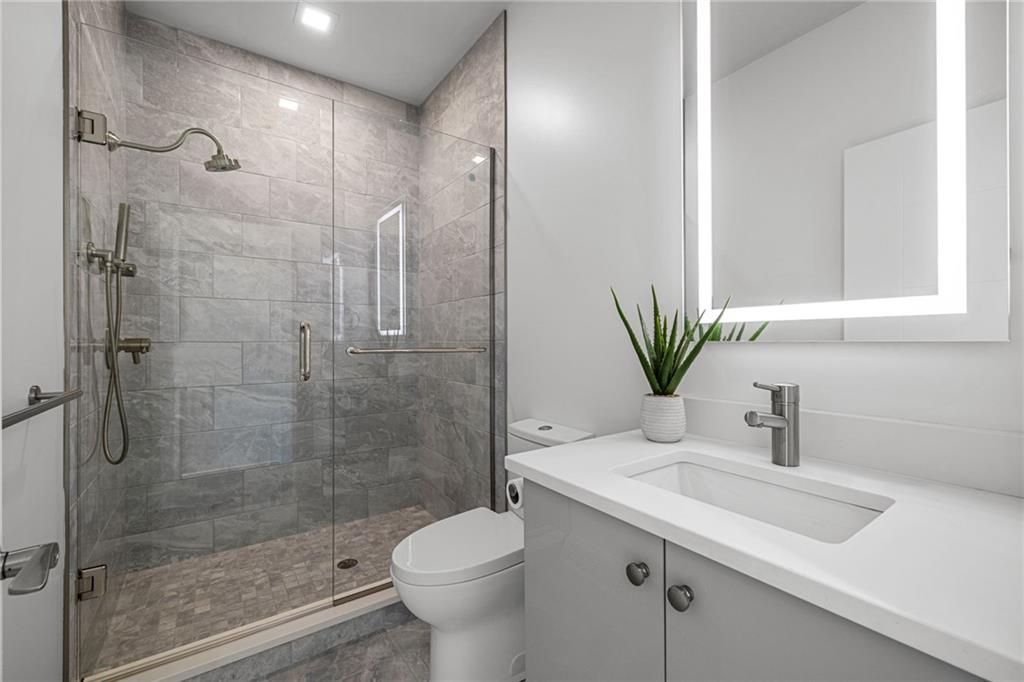 127 1/2 Banner Way Pittsburgh, PA 15201 - Photo 20 of 48 a bathroom with a shower sink vanity mirror and toilet