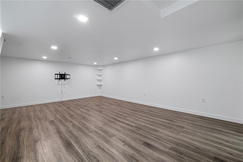 127 1/2 Banner Way Pittsburgh, PA 15201 - Photo 35 of 48 an empty room with wooden floor and a ceiling fan