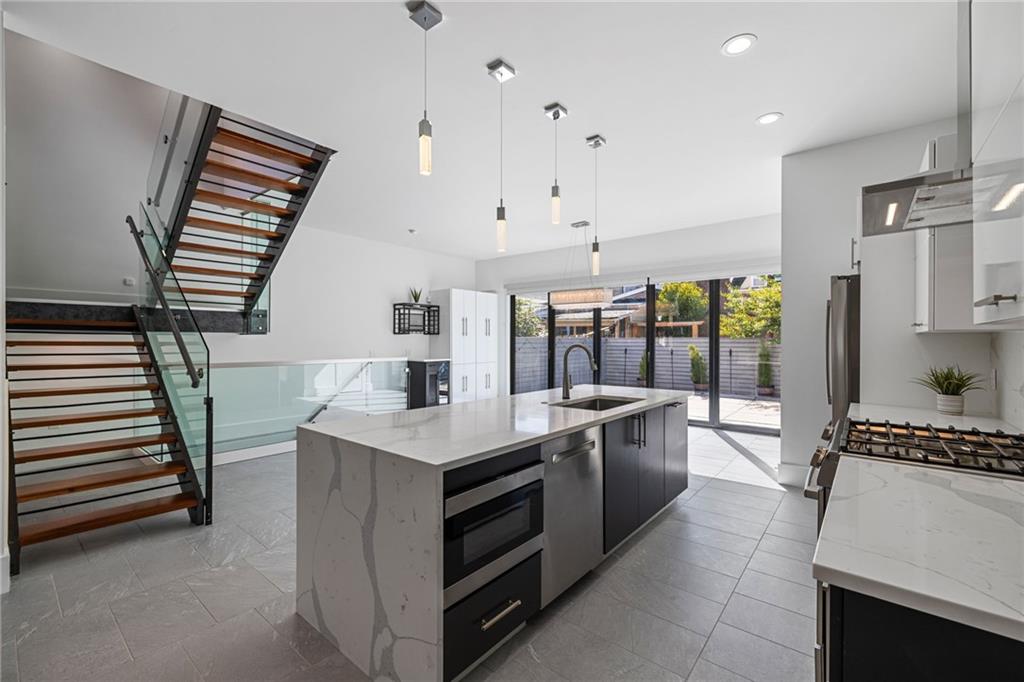 127 1/2 Banner Way Pittsburgh, PA 15201 - Photo 5 of 48 a large white kitchen with a large window