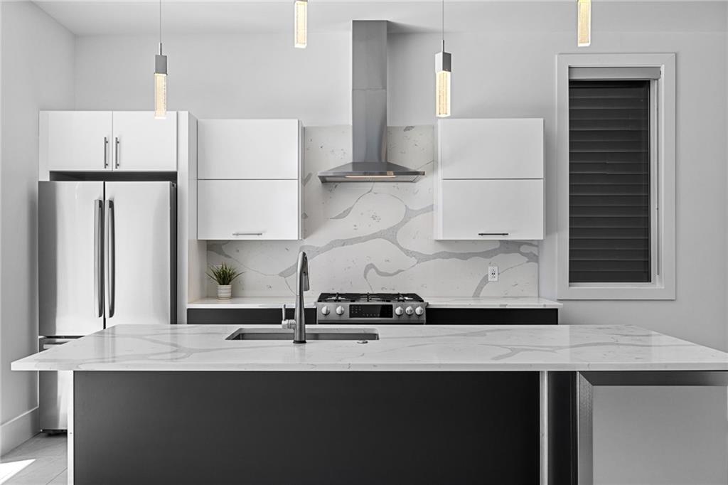 127 1/2 Banner Way Pittsburgh, PA 15201 - Photo 6 of 48 a kitchen with a sink a refrigerator and white cabinets