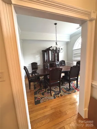 a view of a dining room with furniture and chandelier