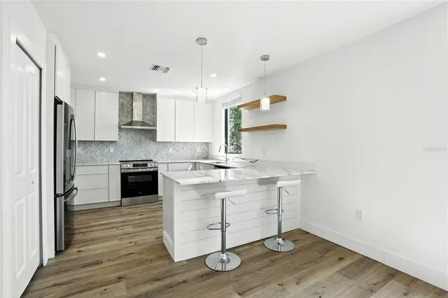a kitchen with a sink stainless steel appliances and cabinets