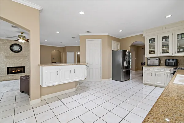 a kitchen with white cabinets and white appliances