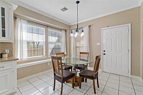 a spacious bedroom with a bed and a chandelier
