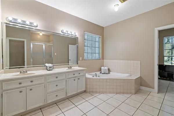 a bathroom with a bathtub and a shower