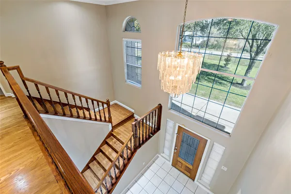 a view of a room with wooden floor and a ceiling fan