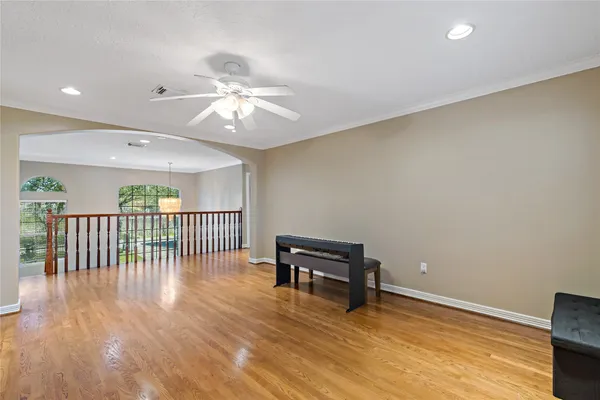 a view of an empty room with window and wooden floor