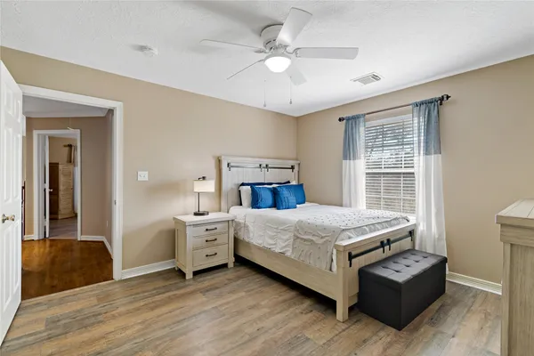 a bedroom with a large bed and a chandelier