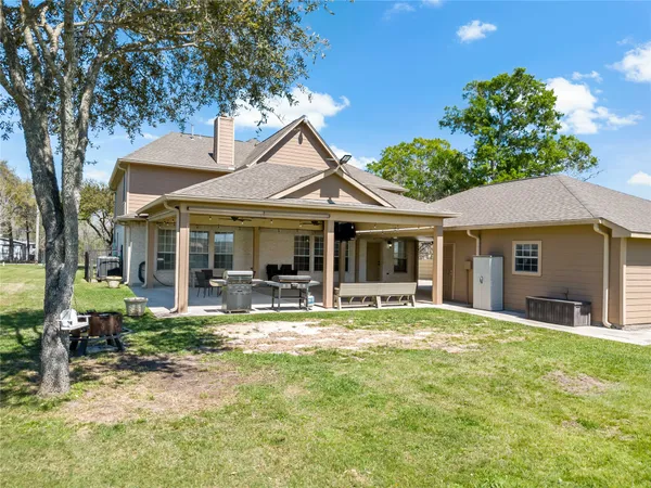 a front view of a house with garden and trees