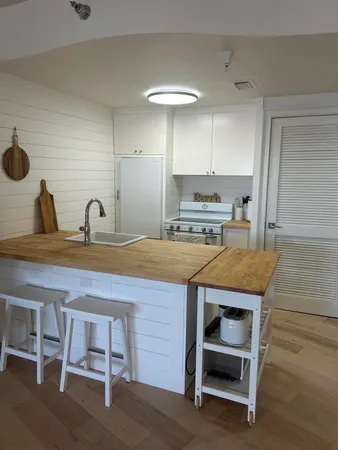 a kitchen with kitchen island stainless steel appliances and wooden cabinets