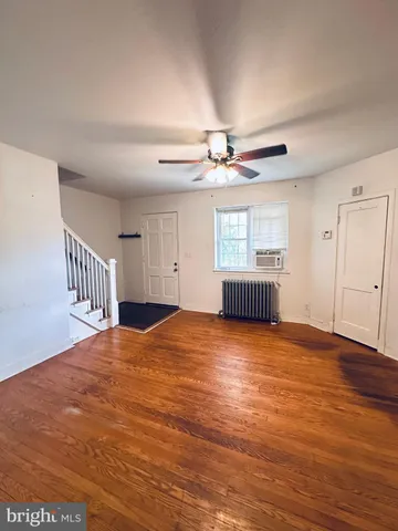 a view of kitchen with refrigerator stove and wooden floor