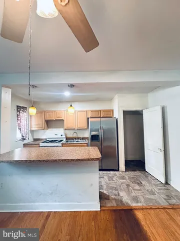 a kitchen with a refrigerator a sink and cabinets