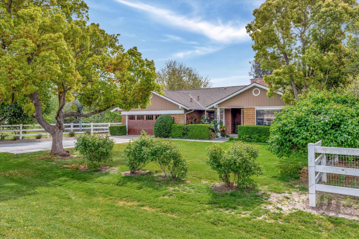1660 Eberts Drive San Martin, CA 95046 - Photo 2 of 77 a front view of a house with a yard