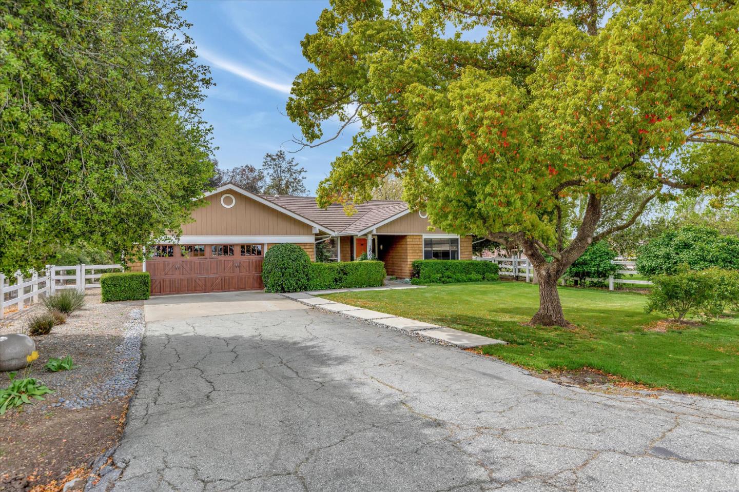 1660 Eberts Drive San Martin, CA 95046 - Photo 5 of 77 a front view of a house with a yard and garage