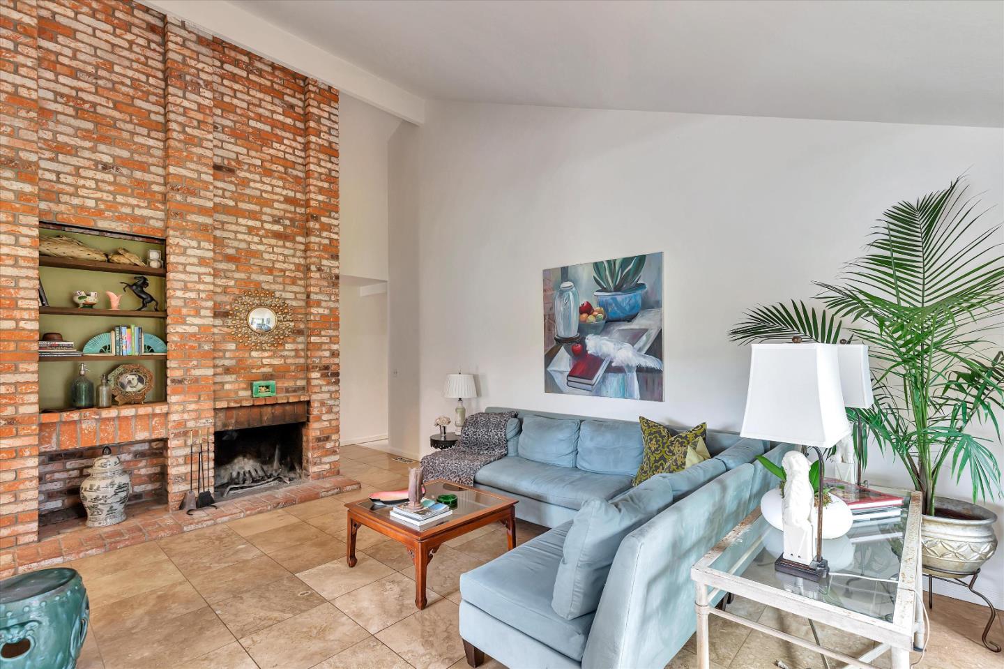 1660 Eberts Drive San Martin, CA 95046 - Photo 7 of 77 a living room with furniture a fireplace and a potted plant