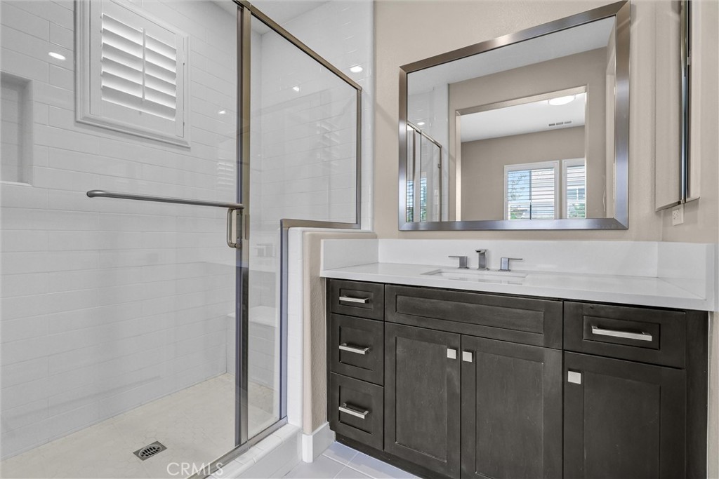 111 Drama Irvine, CA 92618 - Photo 12 of 28 a bathroom with a shower sink and mirror