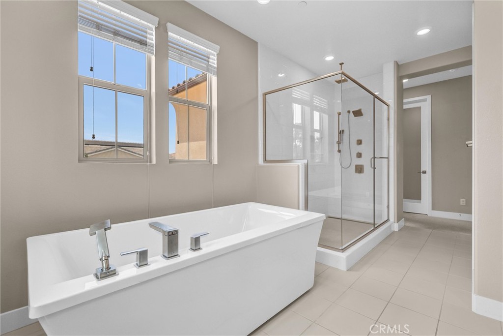 111 Drama Irvine, CA 92618 - Photo 18 of 28 a bathroom with a tub a sink and shower