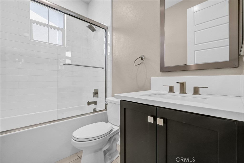 111 Drama Irvine, CA 92618 - Photo 21 of 28 a bathroom with a granite countertop sink toilet and shower