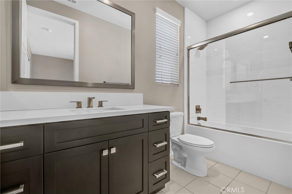 111 Drama Irvine, CA 92618 - Photo 24 of 28 a bathroom with a sink toilet a mirror and shower