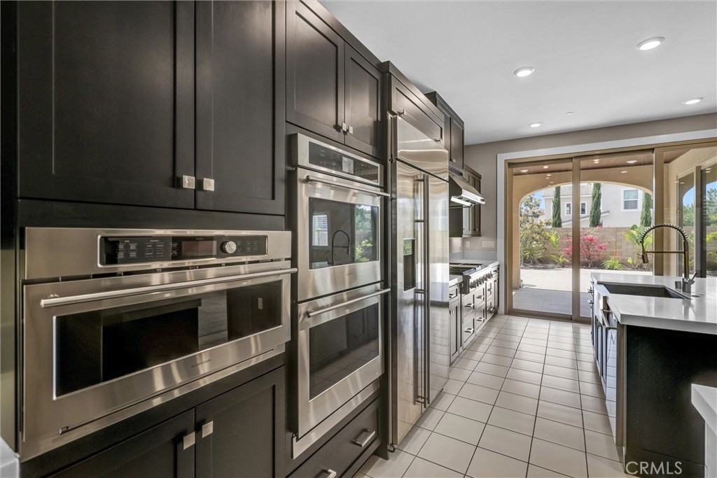 111 Drama Irvine, CA 92618 - Photo 8 of 28 a kitchen with stainless steel appliances granite countertop a stove a sink and a microwave