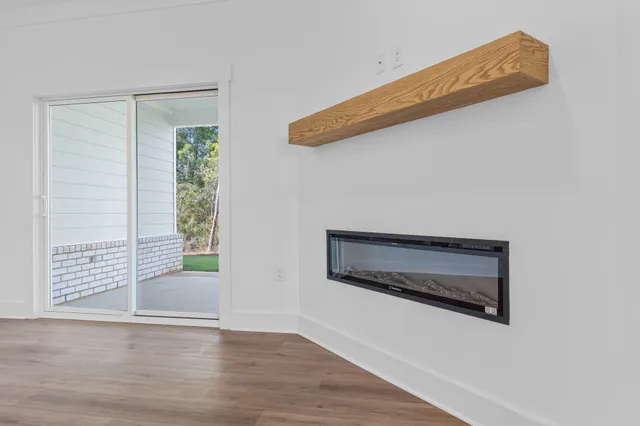 a room with a wooden floor and a window