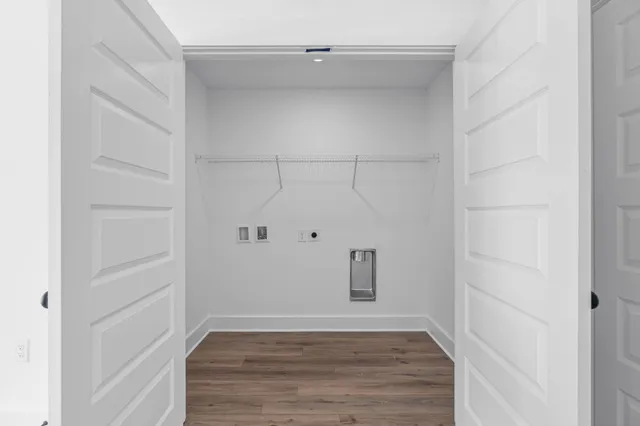 a view of a room with wooden floor