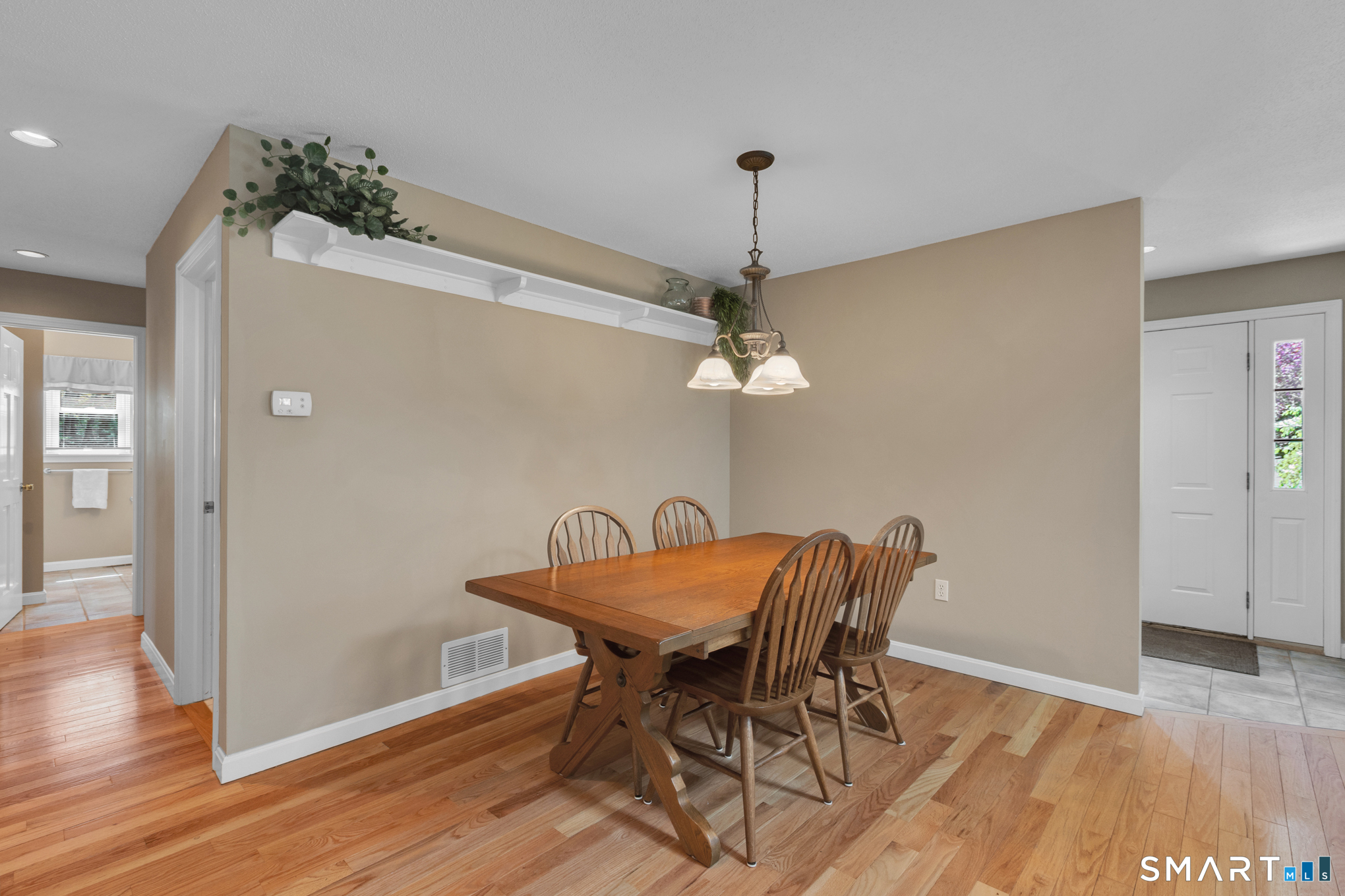 81 Oldefield Farms Road, Unit 81 Enfield, CT 06082 - Photo 12 of 35 a view of a dining room with furniture and wooden floor