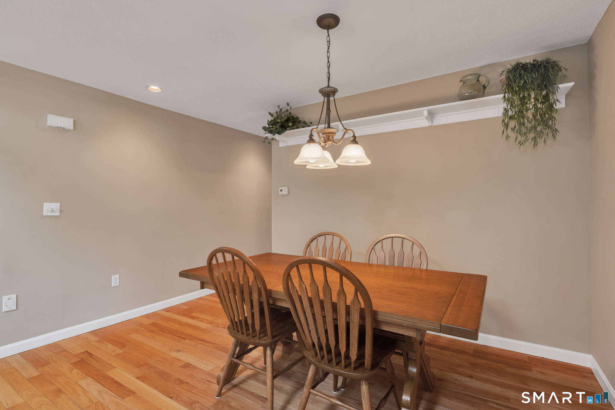 81 Oldefield Farms Road, Unit 81 Enfield, CT 06082 - Photo 13 of 35 a view of a dining room with furniture and wooden floor