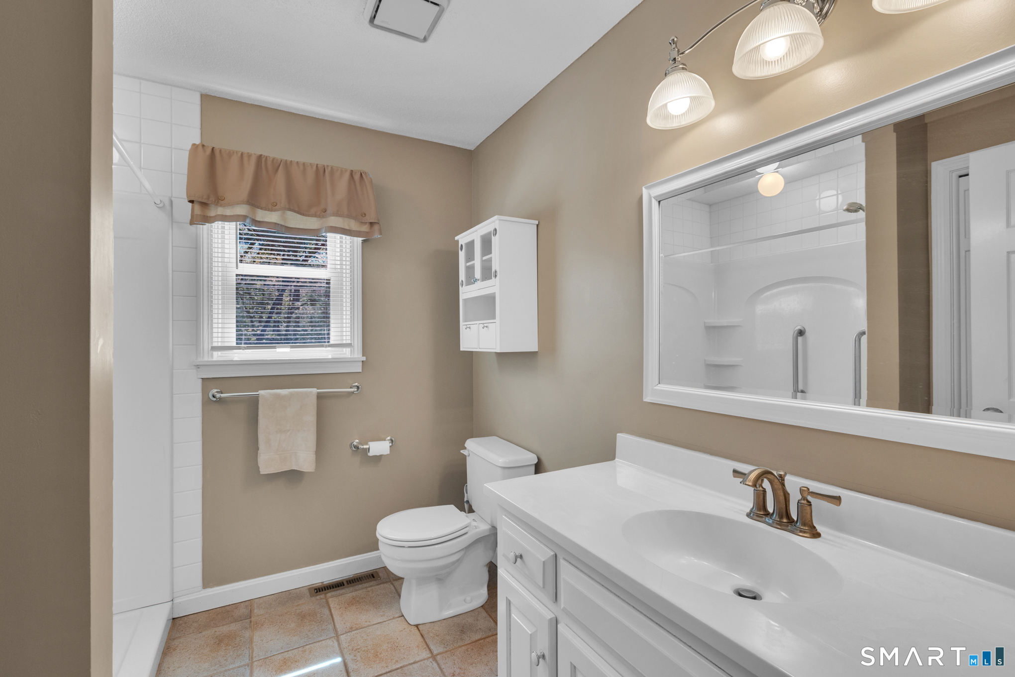 81 Oldefield Farms Road, Unit 81 Enfield, CT 06082 - Photo 17 of 35 a bathroom with a toilet sink vanity and mirror