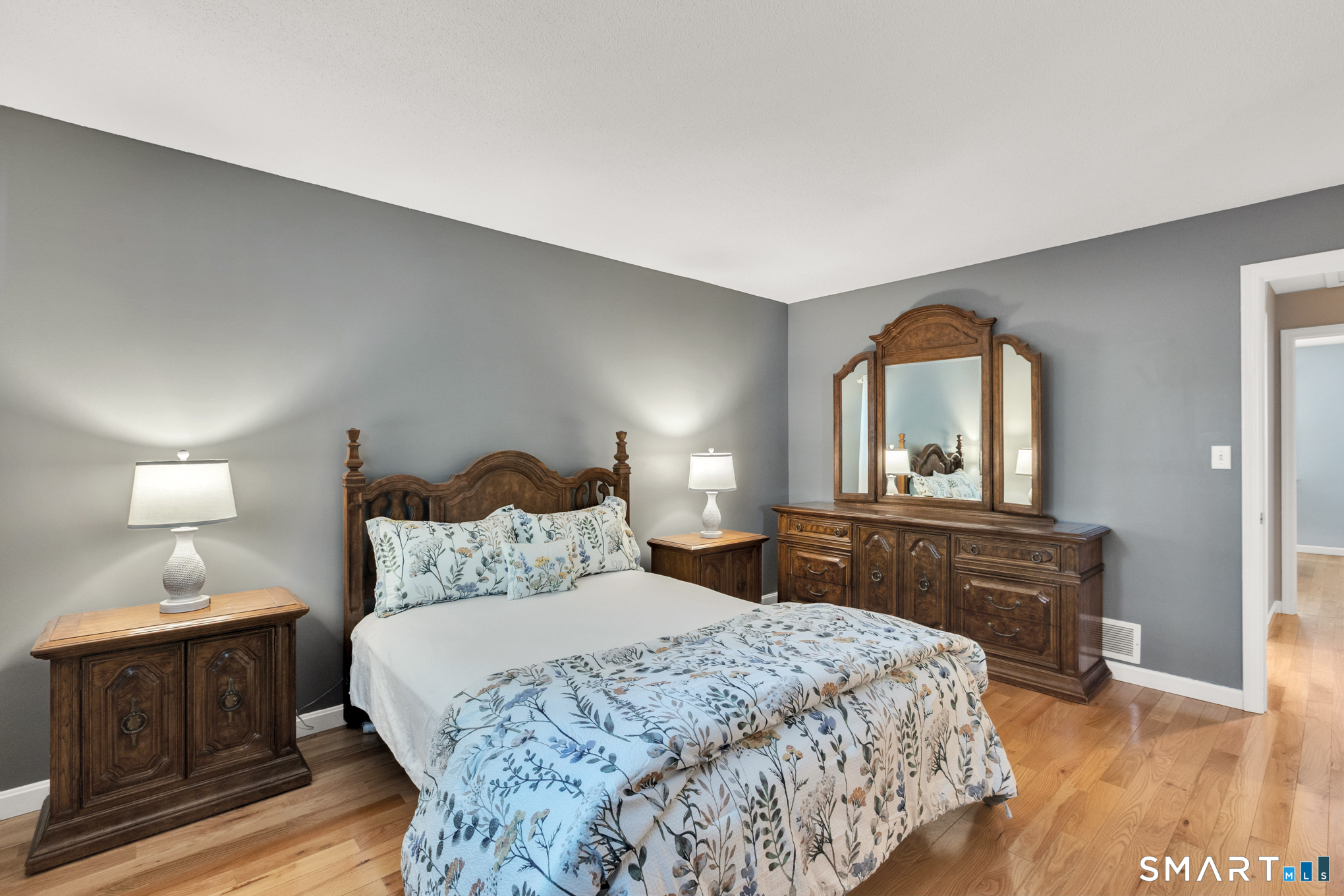 81 Oldefield Farms Road, Unit 81 Enfield, CT 06082 - Photo 20 of 35 a bedroom with a bed and a dresser with wooden floor