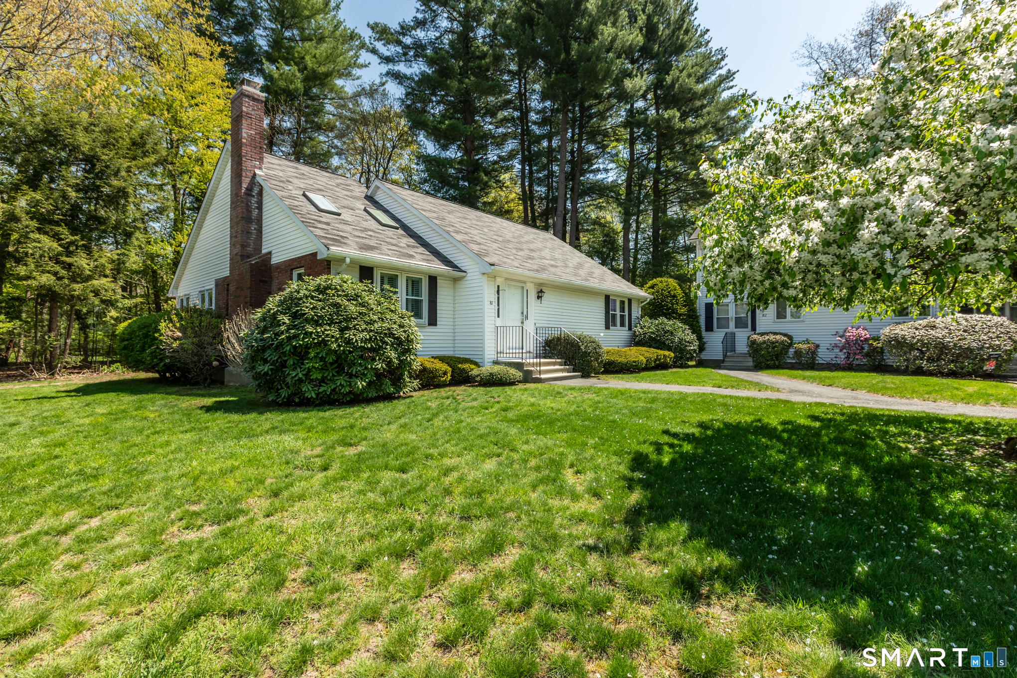 81 Oldefield Farms Road, Unit 81 Enfield, CT 06082 - Photo 2 of 35 a front view of house with yard and green space