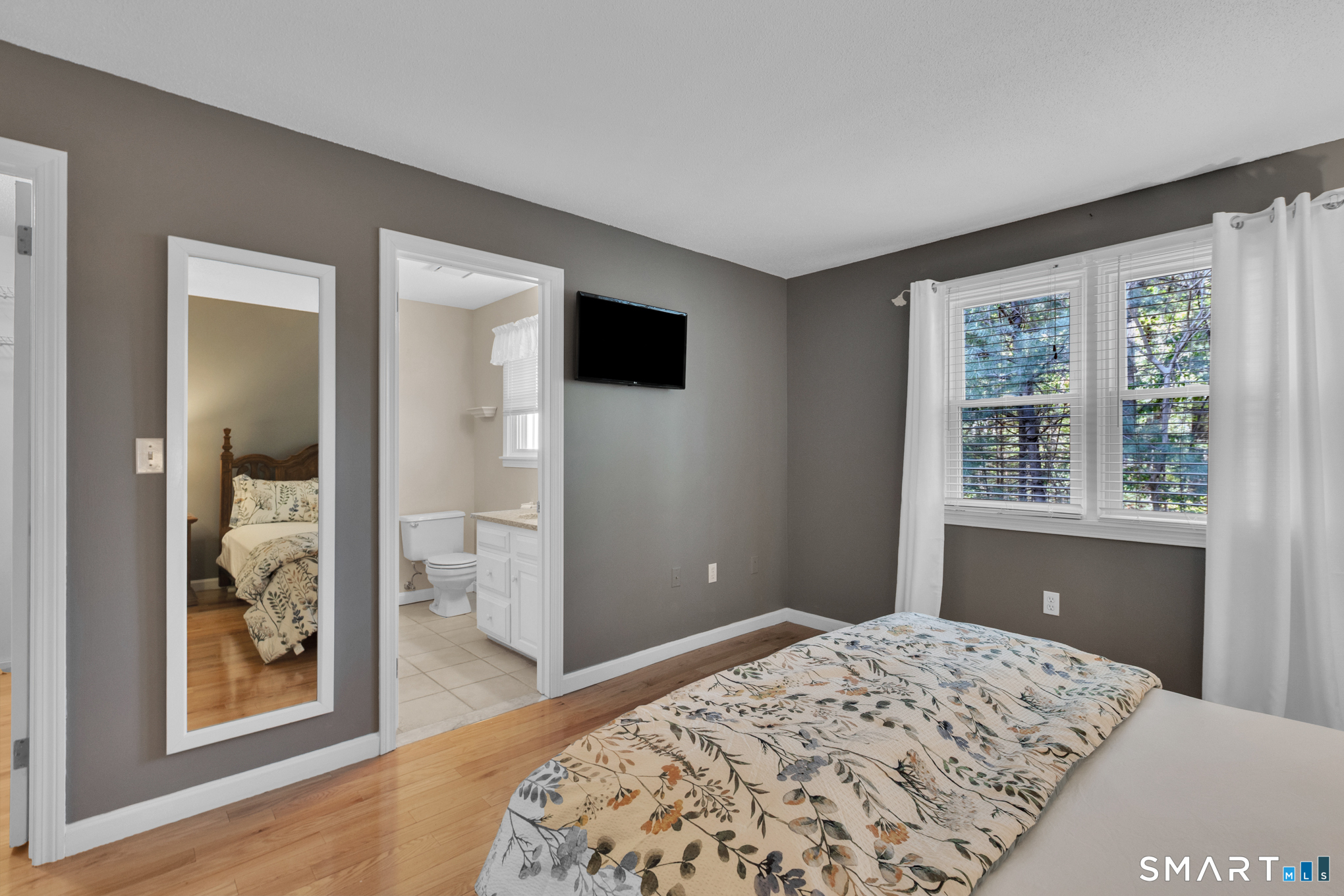 81 Oldefield Farms Road, Unit 81 Enfield, CT 06082 - Photo 21 of 35 a bedroom with a bed and a window
