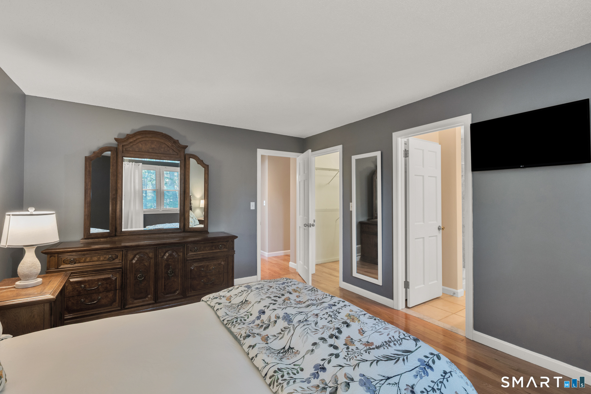 81 Oldefield Farms Road, Unit 81 Enfield, CT 06082 - Photo 23 of 35 a bedroom with a bed and a dresser in it
