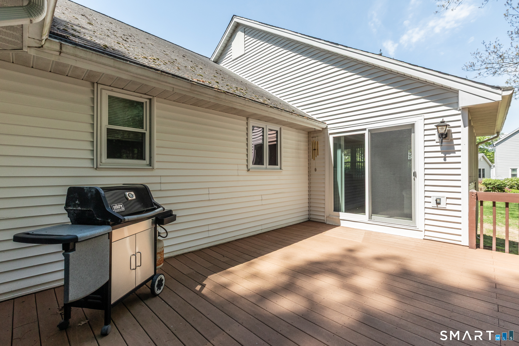 81 Oldefield Farms Road, Unit 81 Enfield, CT 06082 - Photo 30 of 35 a view of a deck with wooden floor and a barbeque