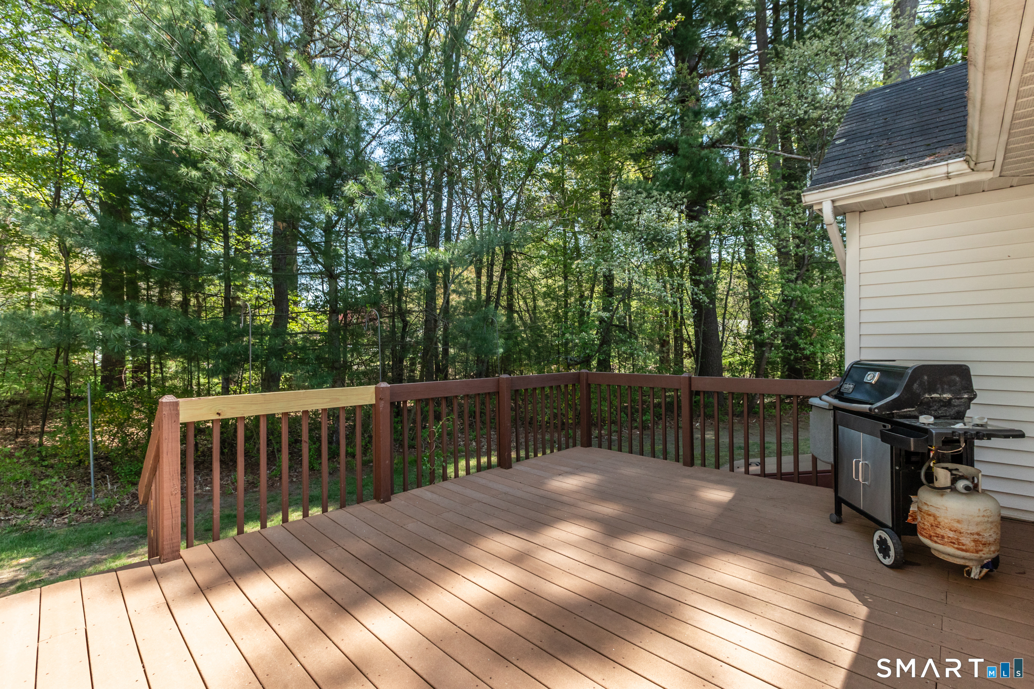 81 Oldefield Farms Road, Unit 81 Enfield, CT 06082 - Photo 32 of 35 a view of a wooden deck and a backyard