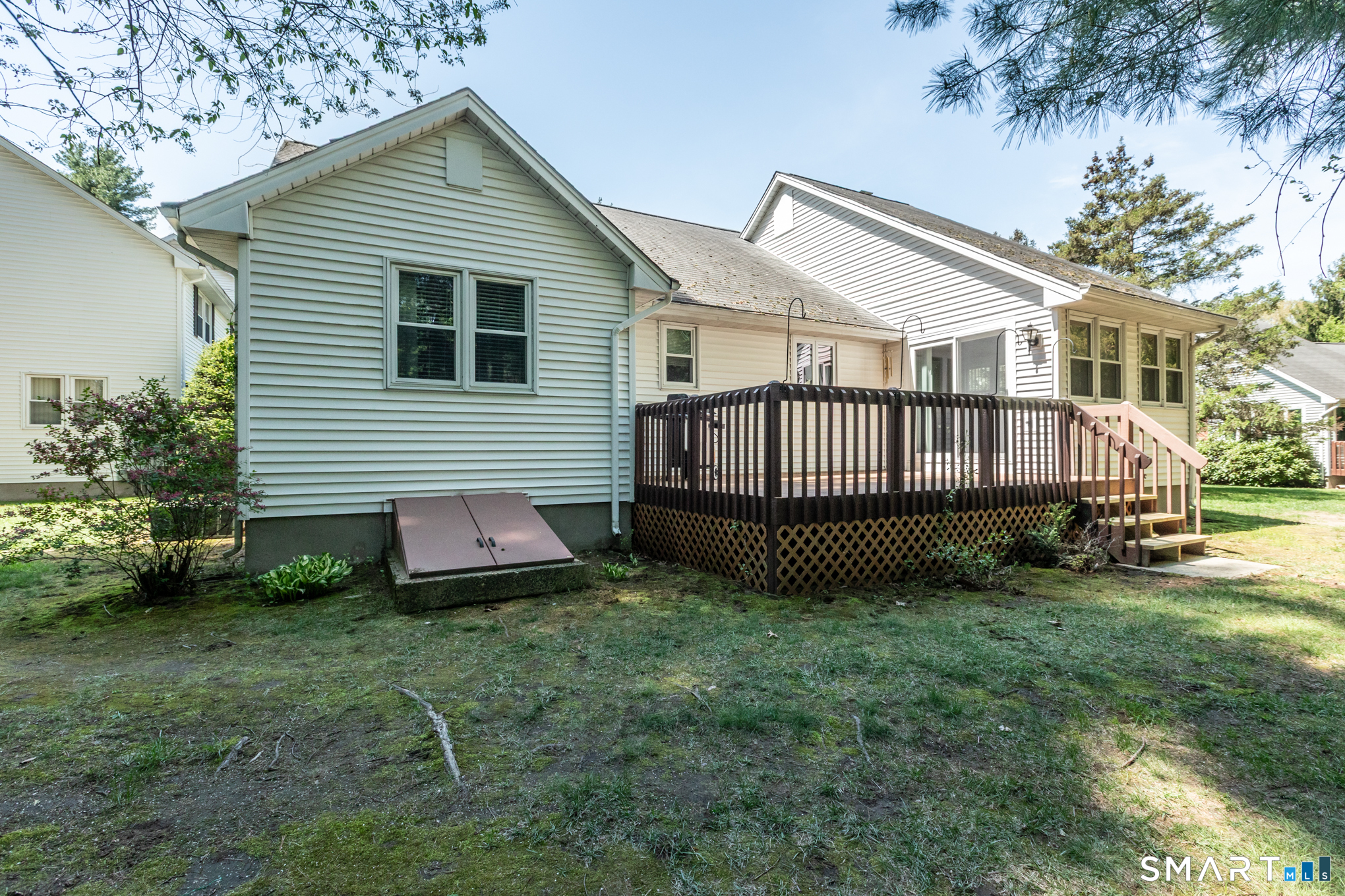 81 Oldefield Farms Road, Unit 81 Enfield, CT 06082 - Photo 33 of 35 a view of a house with a yard and a garden