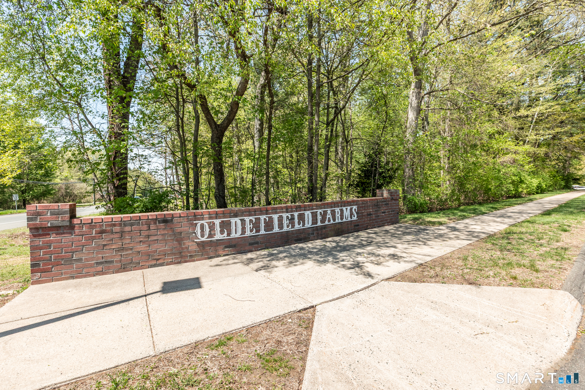 81 Oldefield Farms Road, Unit 81 Enfield, CT 06082 - Photo 35 of 35 a view of a street with trees in the background