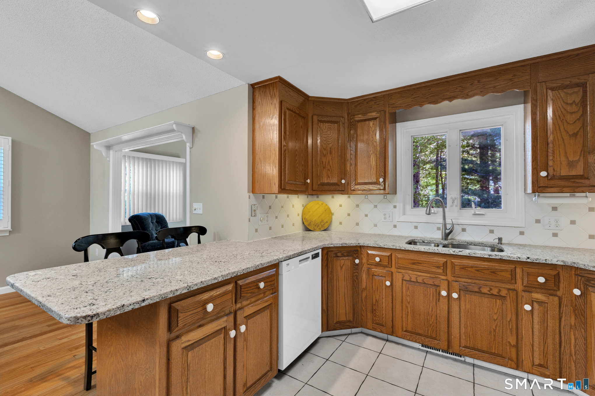 81 Oldefield Farms Road, Unit 81 Enfield, CT 06082 - Photo 10 of 35 a kitchen with a sink dishwasher and cabinets