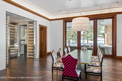 a living room with furniture a wooden floor and next to a window