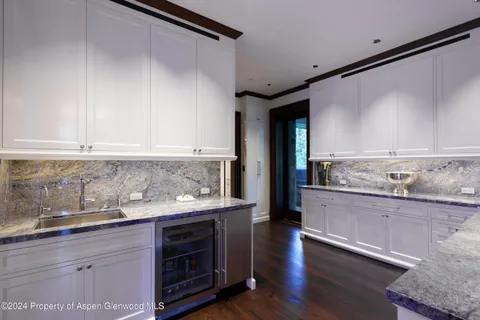 a kitchen with stainless steel appliances granite countertop a stove and a sink with cabinets