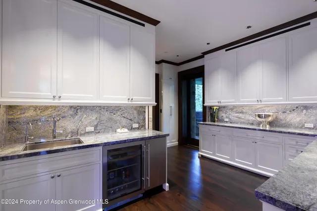a kitchen with stainless steel appliances granite countertop a stove and a sink with cabinets