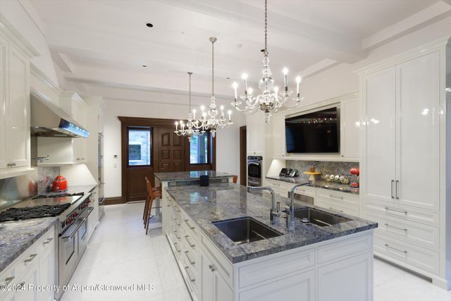 a kitchen with stainless steel appliances granite countertop a sink and a stove