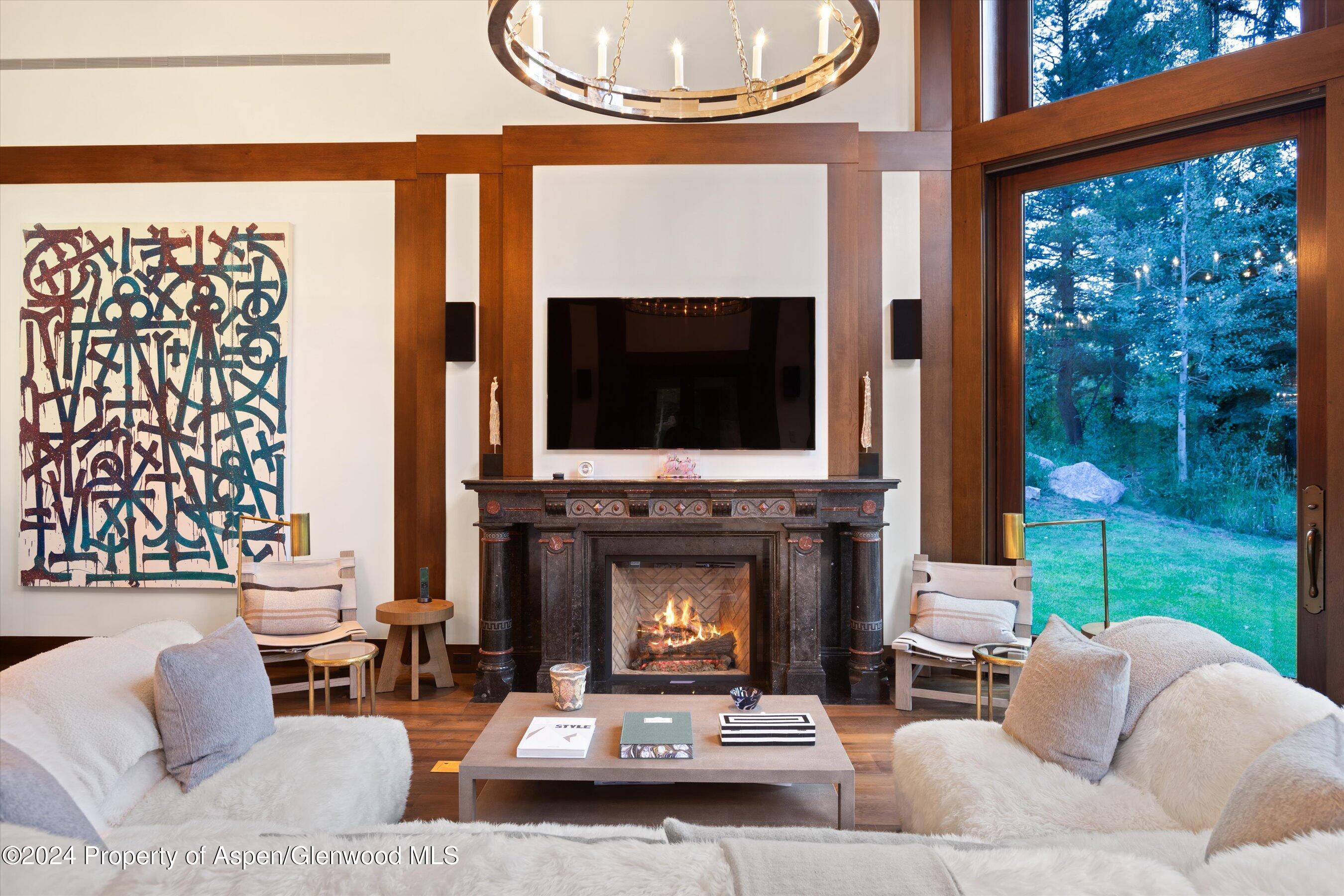 41 Popcorn Lane Aspen, CO 81611 - Photo 20 of 54 a living room with furniture a fireplace and a flat screen tv